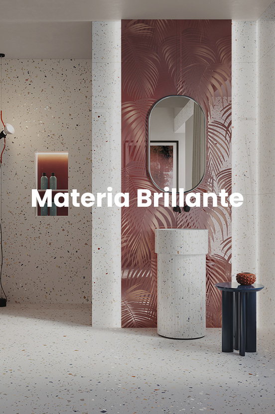 Bathroom with light terrazzo-effect stoneware flooring and walls, glossy red tropical decoration, cylindrical sink, and oval mirror.