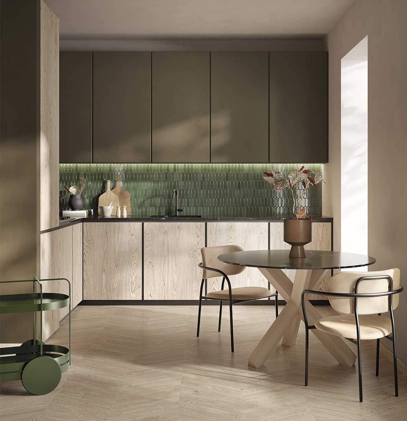 Modern kitchen with plug-in wood effect floor, light wood base units, olive green wall units and glossy green ceramic wall tiles, round side table with flower vase, double chair, green trolley on the left.